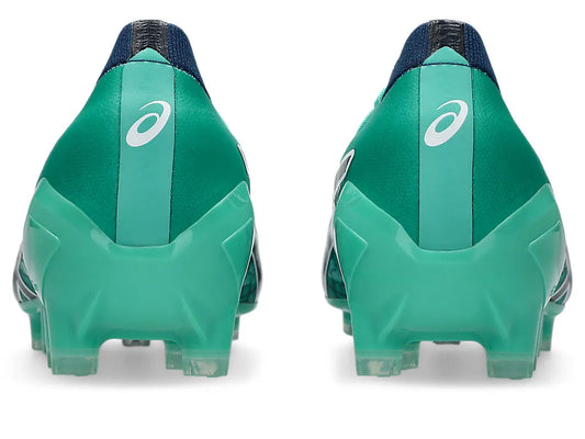 Rear view of a pair of ASICS Menace 5 boots, showing the Aurora Green upper, light green heel counters with white ASICS logos, dark navy ankle collars, and molded studs.