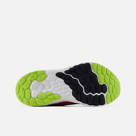 Bottom view of the rubber outsole on the New Balance Kids Arishi v4 running shoe, featuring a bright alkaline green tread pattern combined with black traction pads against a light grey background.