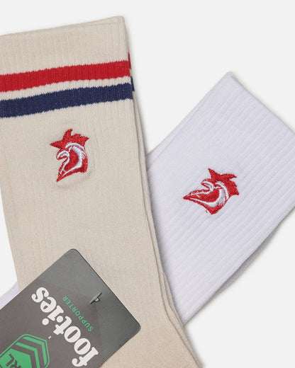 Two pairs of crew socks displayed diagonally on a light gray background. One pair is cream/beige with red and navy blue stripes near the cuff and a red and white bird logo embroidered on the front.