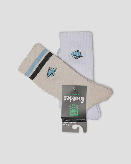 A pair of Footies NFL crew socks, one cream and one white, both featuring a Carolina Panthers logo on the upper calf and a striped cuff. The cream sock has light blue and black stripes, while the white sock has a single light blue stripe.