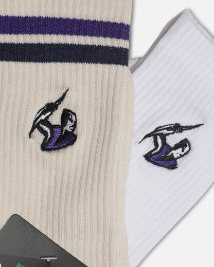A pair of crew socks shown in a close-up product shot. One sock is cream with dark navy and purple stripes near the top and a small embroidered black-and-purple logo on the leg.