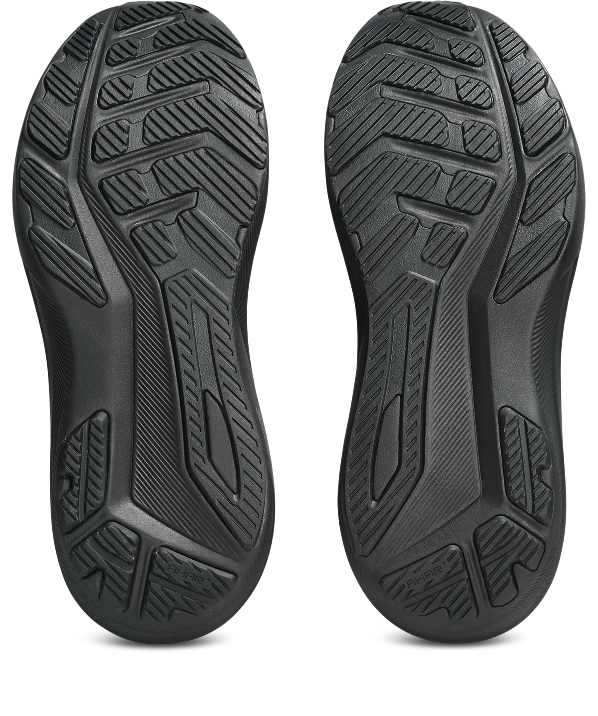 A pair of black athletic shoe soles shown from the bottom, featuring deep tread patterns and textured rubber grooves, isolated on a white background.