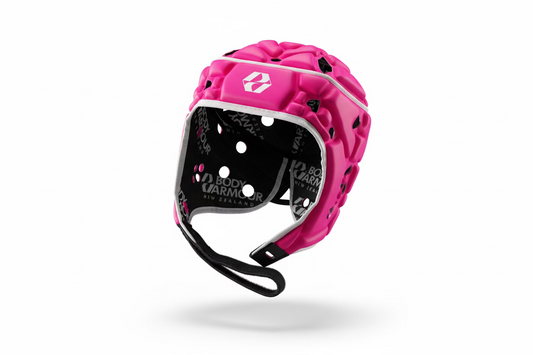 Pink and black helmet with visible branding on a patterned surface