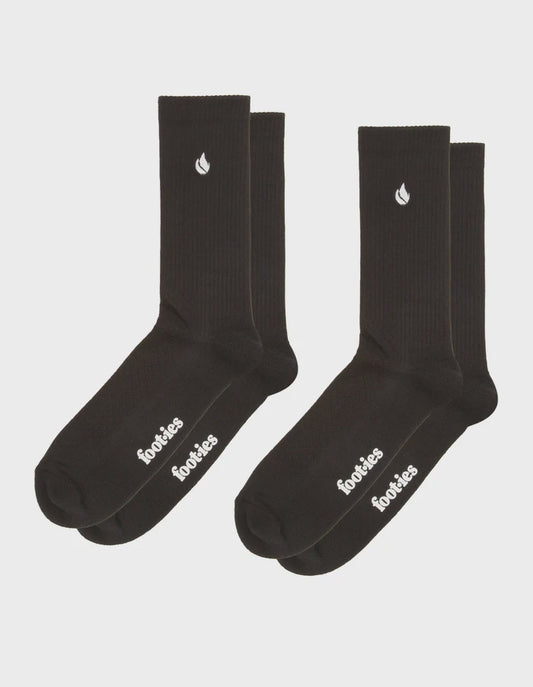 Two pairs of black foot-ies Blaze sneaker socks with white flame logos on the cuffs and white branding on the feet.