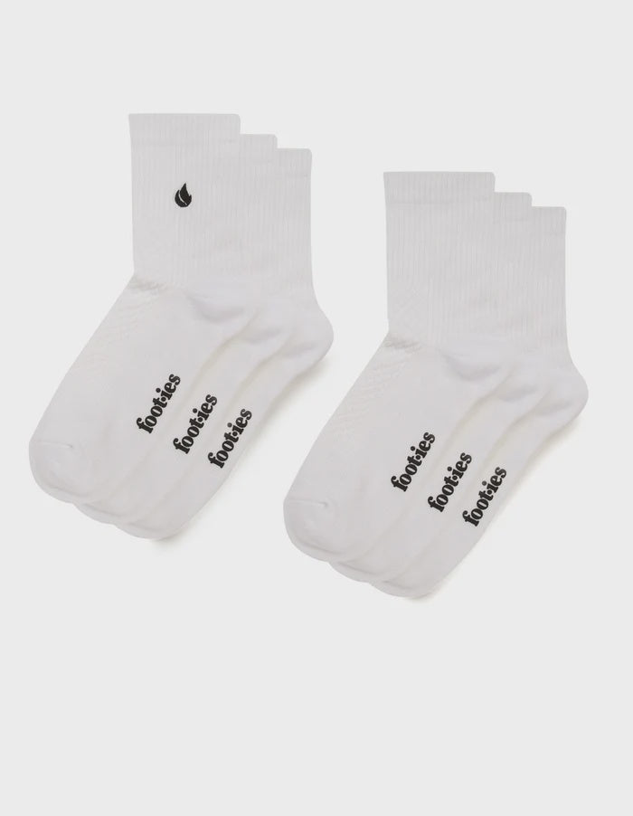 Three pairs of white foot-ies Blaze half crew socks with black foot-ies branding and a black flame logo.
