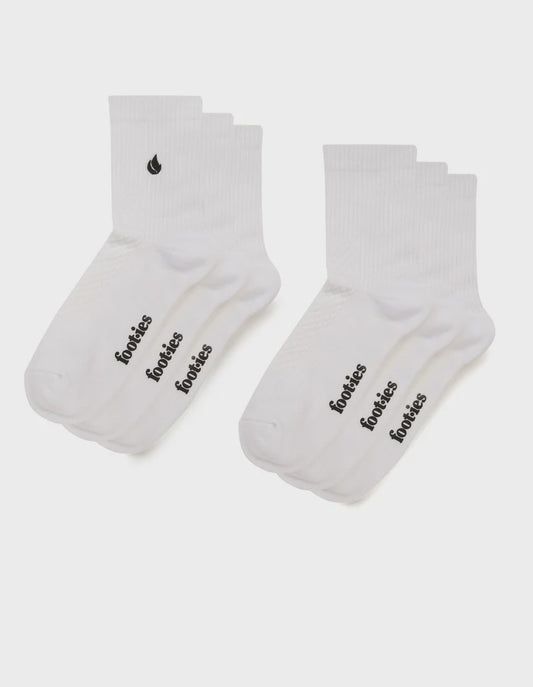Three pairs of white foot-ies Blaze half crew socks with black foot-ies branding and a black flame logo.