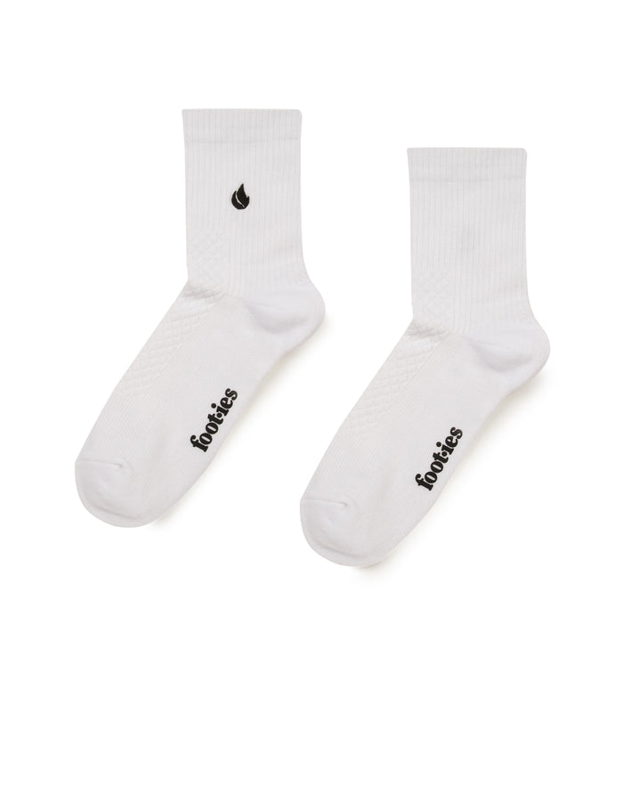 Pair of white foot-ies Blaze half crew socks showing black branding on the feet and a black flame logo on one cuff.
