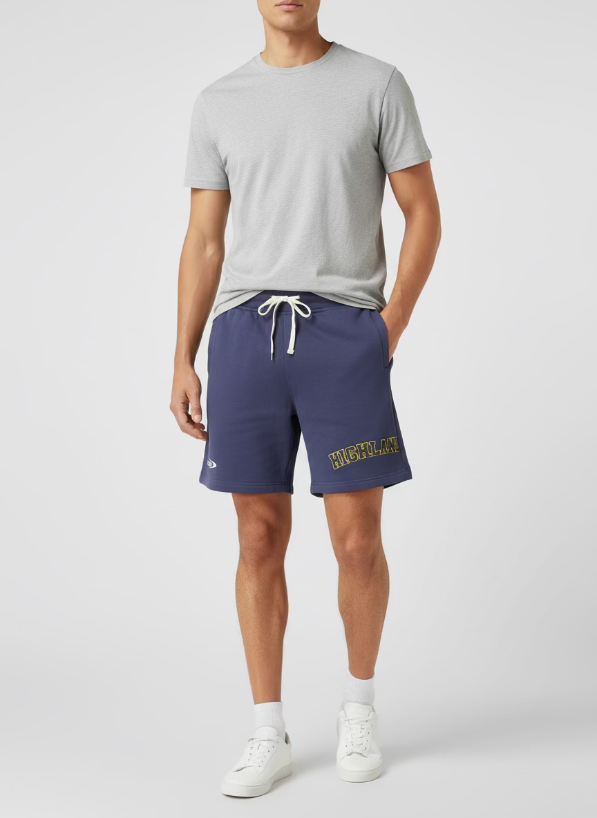 Purple shorts with yellow text on a textured surface