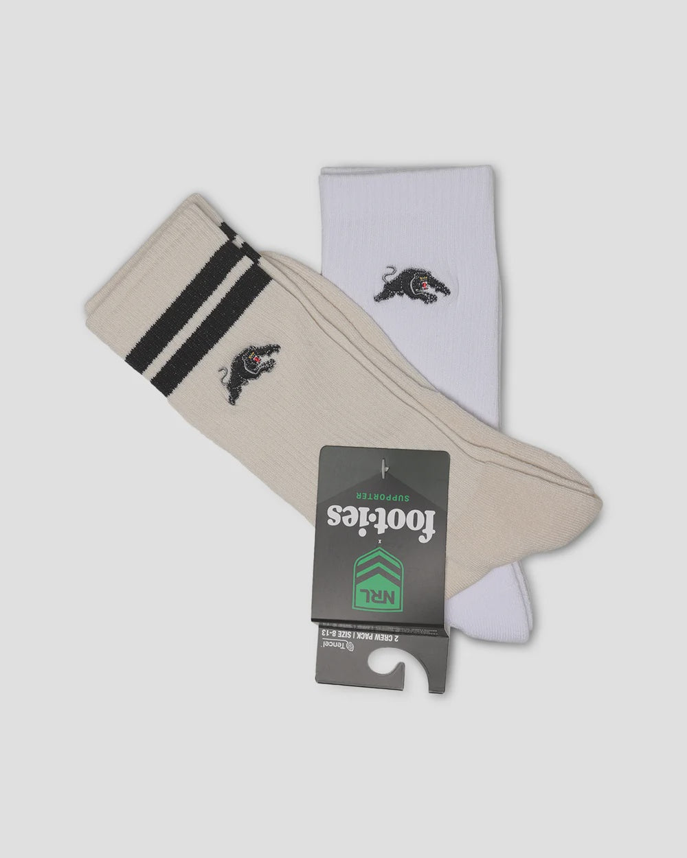 A pair of Footies crew socks, one in beige with black stripes and a black panther logo, and one in white with a black panther logo, displayed with a black retail hangtag on a light gray background.
