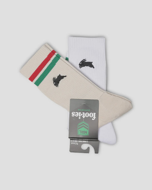 A pair of ankle socks with a black rabbit logo, featuring one cream sock with green and red stripes and one white sock, both with a grey 'footies NRL' hangtag.
