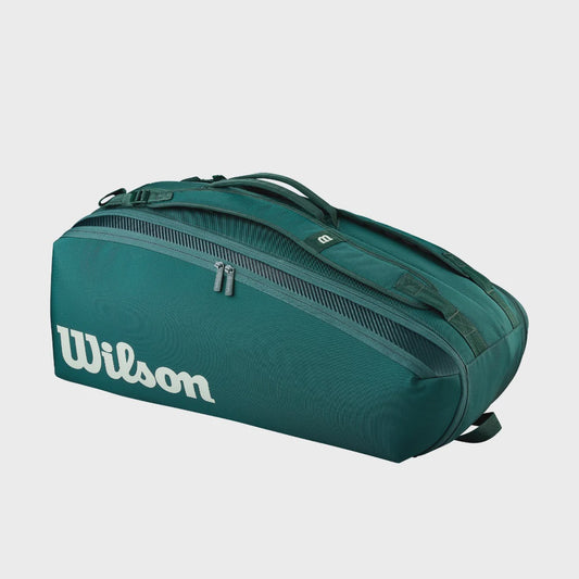 Angled view of green Wilson Blade V10 nine-racket bag with white Wilson logo and padded shoulder straps.