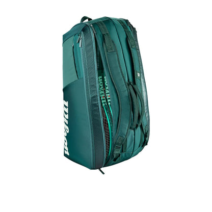 Green Wilson Blade V10 racket bag standing upright with rackets visible in an open compartment.