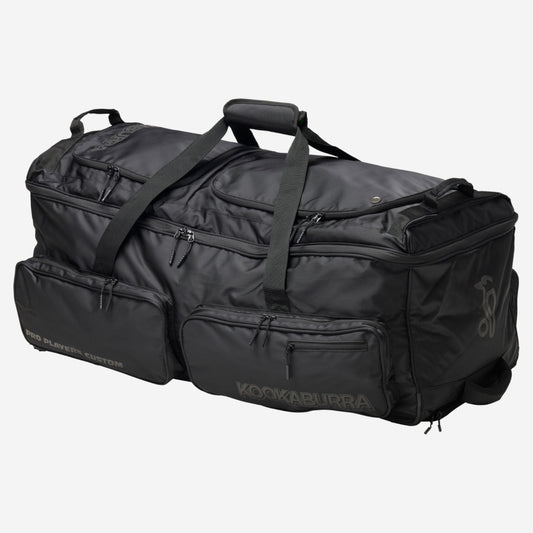 Kookaburra Pro Player Custom Wheel Bag Black - Angled view showing multiple external pockets, top handles, and tank wheels