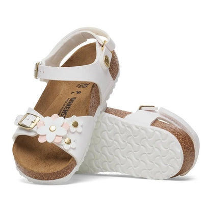 White children's sandals with floral design and gold accents on a white background