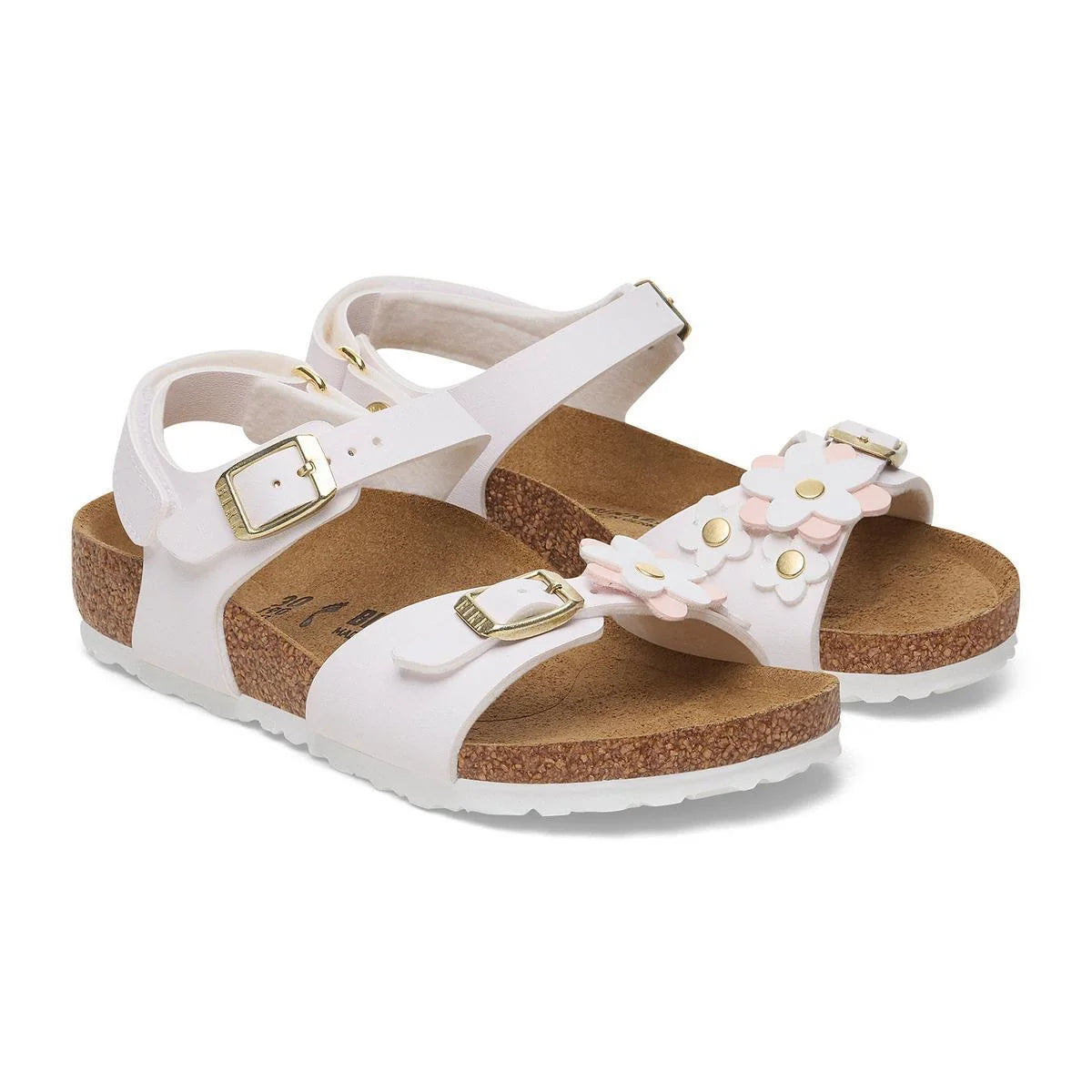 White sandals with cork soles and floral decorations on a white background