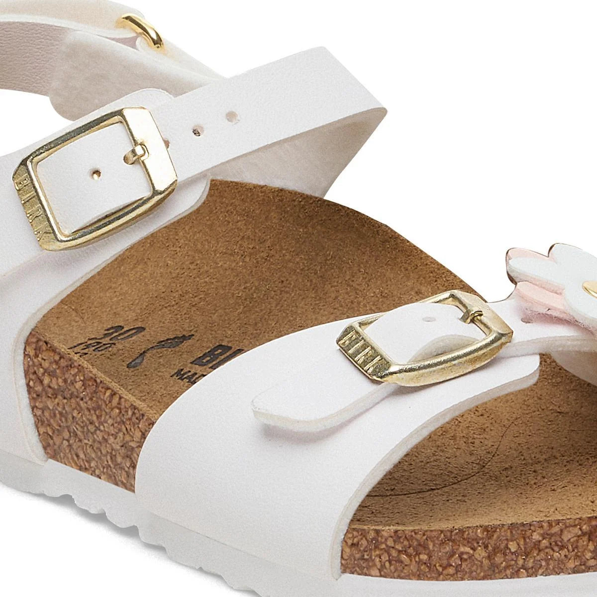 White Birkenstock sandal with gold-tone buckles and a cork footbed, shown in a close-up studio shot.