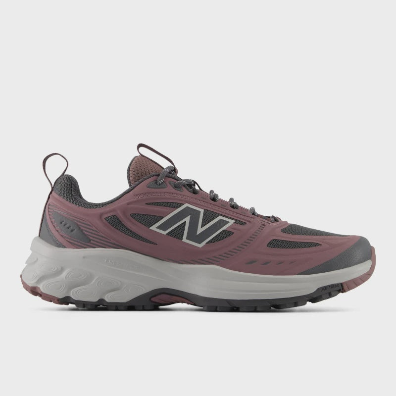 Side profile view of a single New Balance Women's 410v9 trail running shoe in Fast Track/Pebble, showing dusty rose-pink overlays, a dark grey mesh upper, silver 'N' logo, and a sculpted light grey Fresh Foam midsole against a light grey background.