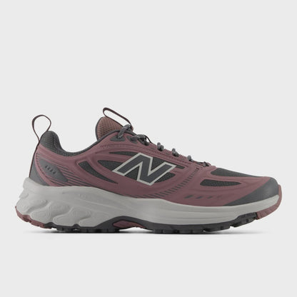Side profile view of a single New Balance Women's 410v9 trail running shoe in Fast Track/Pebble, showing dusty rose-pink overlays, a dark grey mesh upper, silver 'N' logo, and a sculpted light grey Fresh Foam midsole against a light grey background.