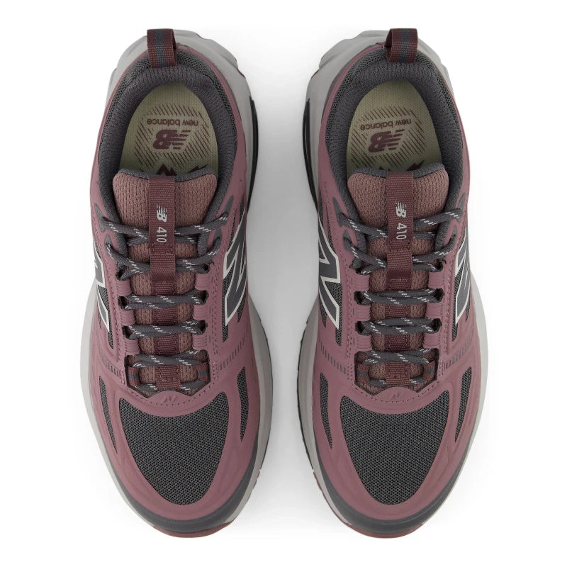 Top view of a pair of New Balance Women's 410v9 trail running shoes in Fast Track/Pebble placed side-by-side, showcasing dark grey mesh toe boxes, dusty rose-pink synthetic overlays, dark grey patterned laces, and grey Fresh Foam midsoles against a white background.