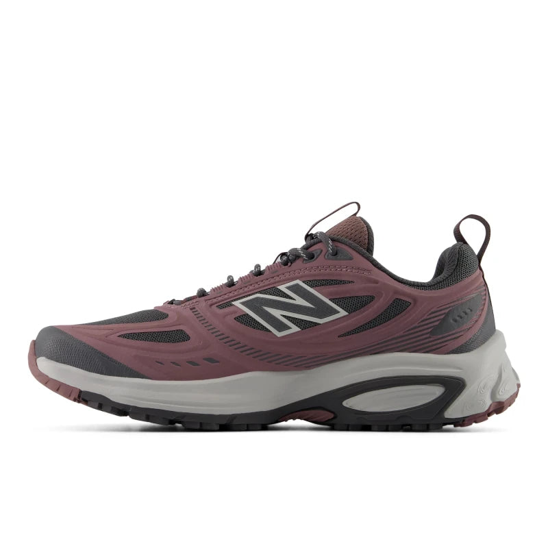 Side profile view of the inner side of a single New Balance Women's 410v9 trail running shoe in Fast Track/Pebble, highlighting the dusty rose-pink synthetic overlays, dark grey mesh upper, dark grey laces, and a thick light grey Fresh Foam midsole against a white background.