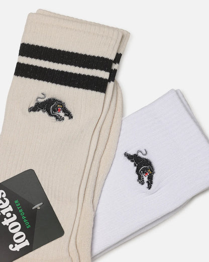 Two pairs of Footes crew socks, one cream and one white, both featuring black stripes near the cuff and a black embroidered panther logo with a small red accent.
