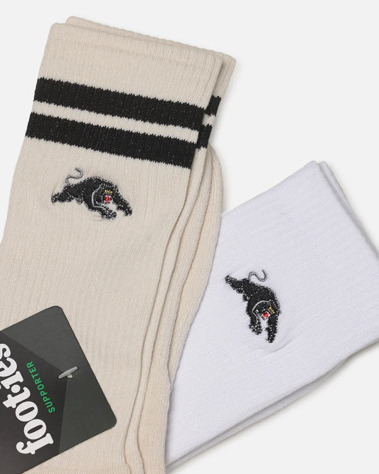 Two pairs of Footes crew socks, one cream and one white, both featuring black stripes near the cuff and a black embroidered panther logo with a small red accent.