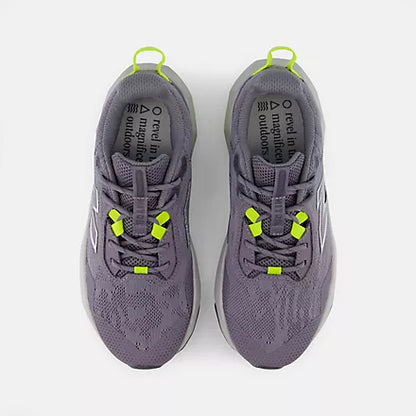 Top view of grey and black New Balance Big Kids Nitrel Lace trail running shoes with yellow-green heel pull tabs and lace loops, shown side by side against a light grey background.
