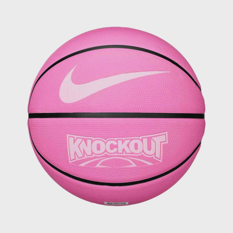 A pink Nike basketball with black seams, a white swoosh logo, and 'KNOCKOUT' printed in white on the front, shown against a light gray background.