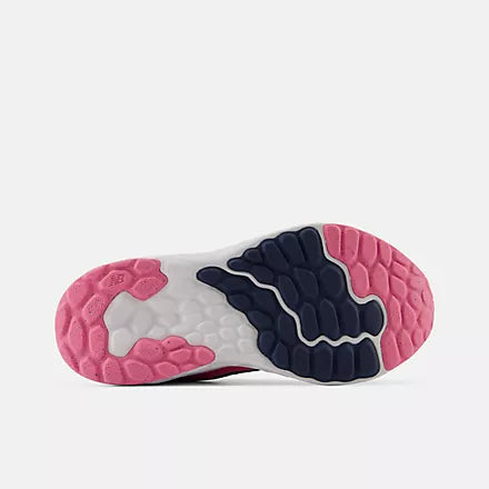 Bottom view of the rubber outsole on the New Balance Kids Arishi v4 running shoe, showing the pink and dark navy blue tread pattern against a light grey background.