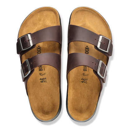 A pair of Birkenstock double-strap slide sandals in dark brown leather with tan suede footbeds and silver-tone metal buckles, shown from a top-down view on a white background.