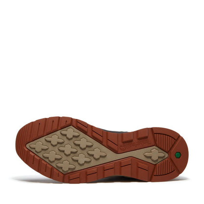 The outsole of a hiking boot shown from a bottom-up view, featuring a brown rubber tread with a beige textured grip pattern and the embossed brand name 'Timberland'.